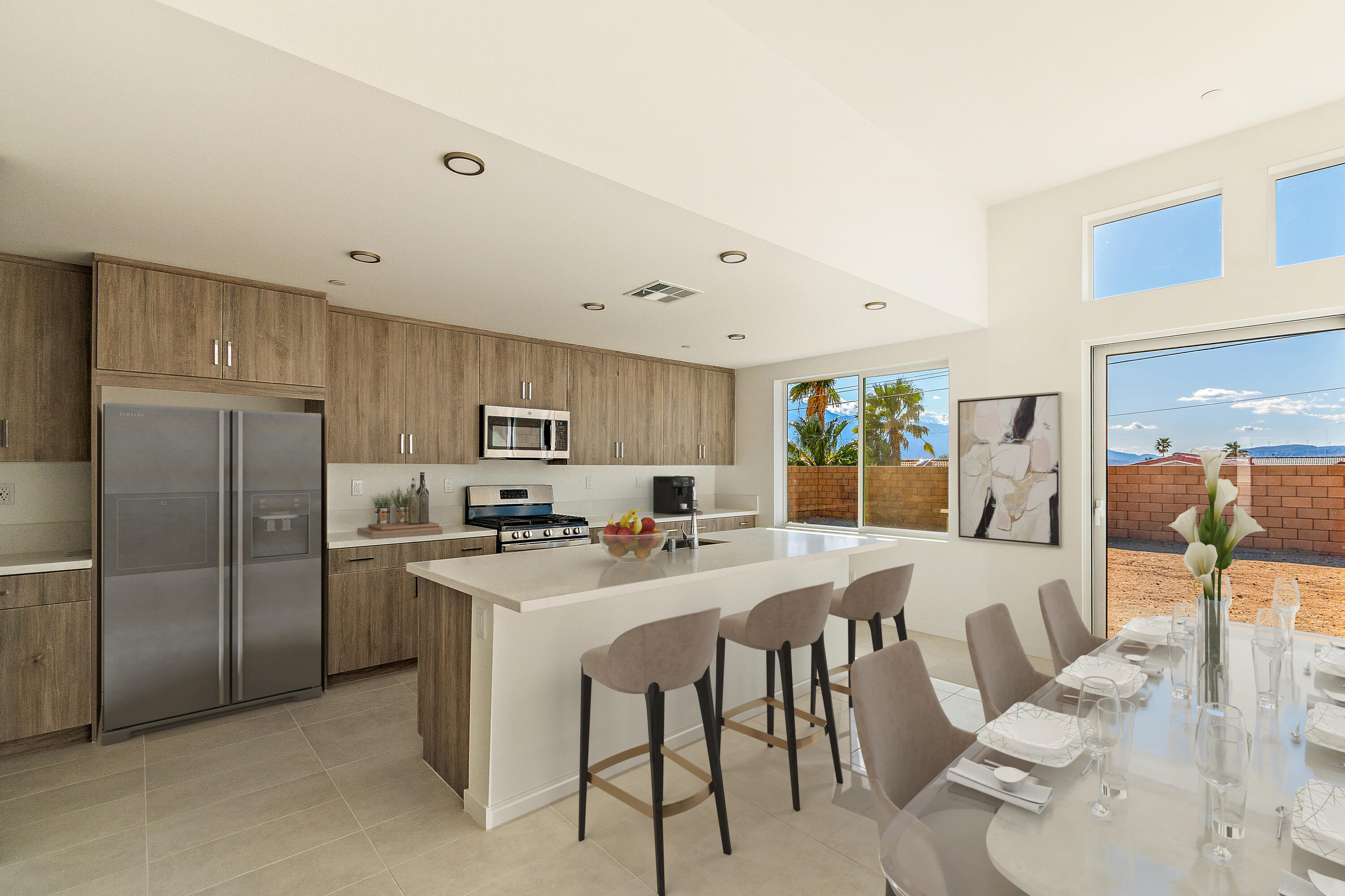 a kitchen with stainless steel appliances a table and chairs