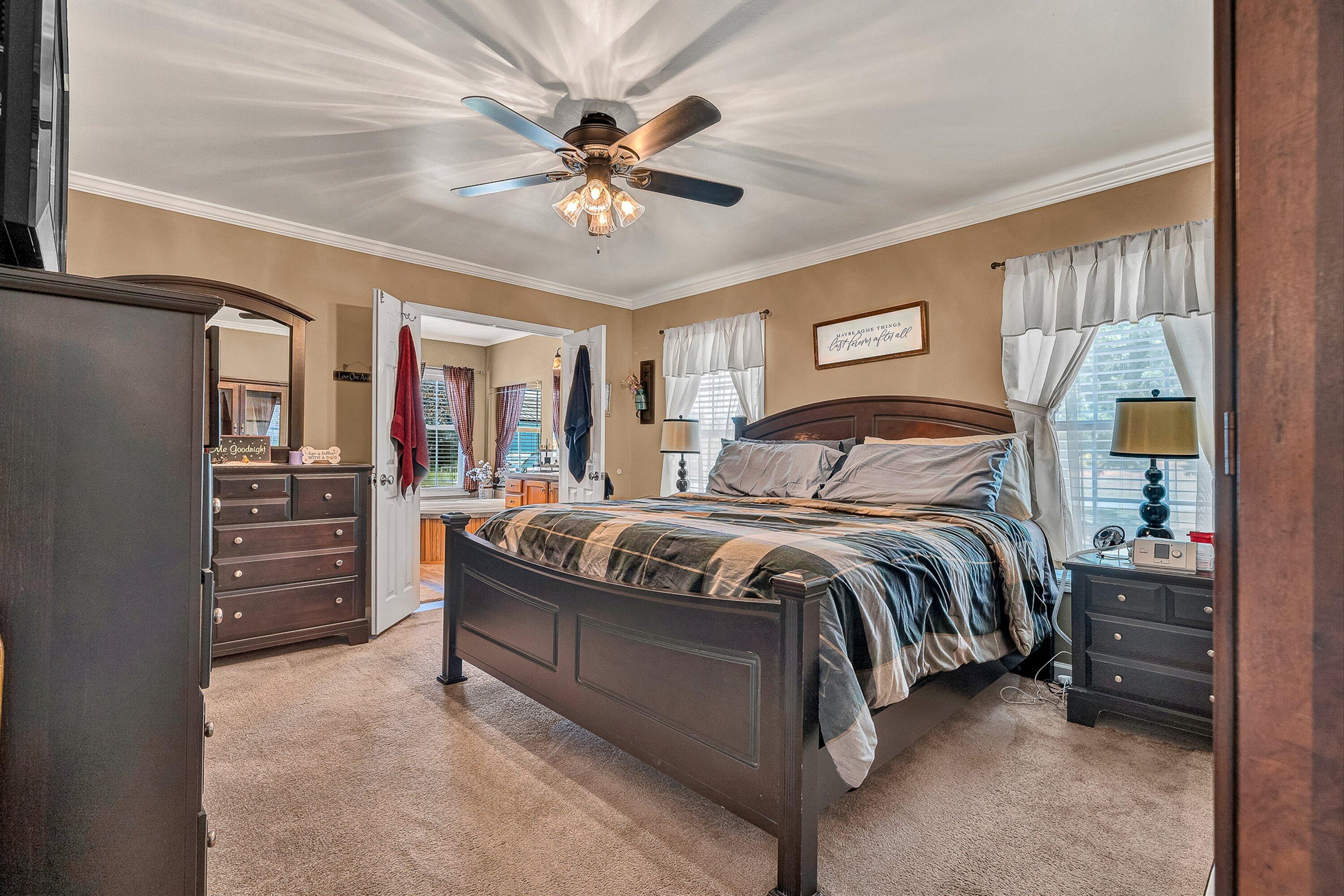 159 Simmons Creek Road Union Hall, VA 24176 - Photo 19 of 55 a bedroom with a bed and a chandelier