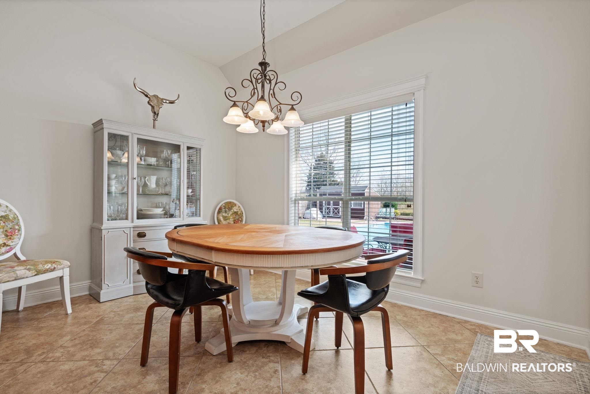 4771 Pecan Ridge East Mobile, AL 36619 - Photo 20 of 48 Dining room featuring a chandelier, vaulted ceiling, and light tile patterned floors
