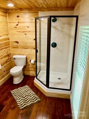 a bathroom with a toilet and a shower
