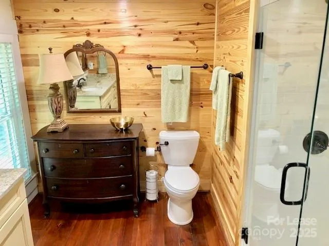 a bathroom with a toilet and a shower