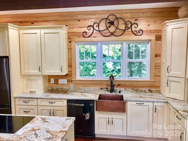a kitchen with a stove a sink and a window