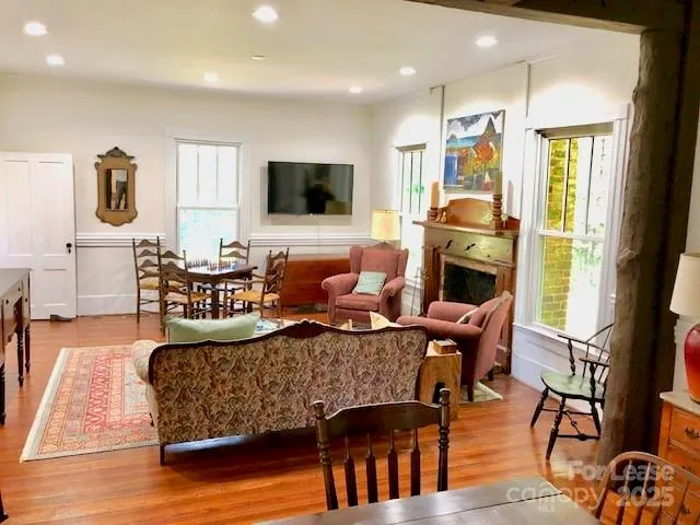 a living room with fireplace furniture and a flat screen tv