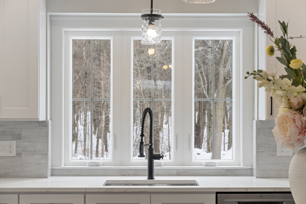 29 Thornton Street Mendon, MA 01756 - Photo 11 of 42 a view of a living room with a window and a chandelier