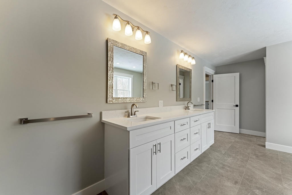 29 Thornton Street Mendon, MA 01756 - Photo 26 of 42 a spacious bathroom with a double vanity sink and mirror