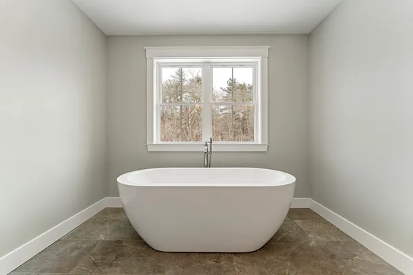 a white tub sitting in a bathroom