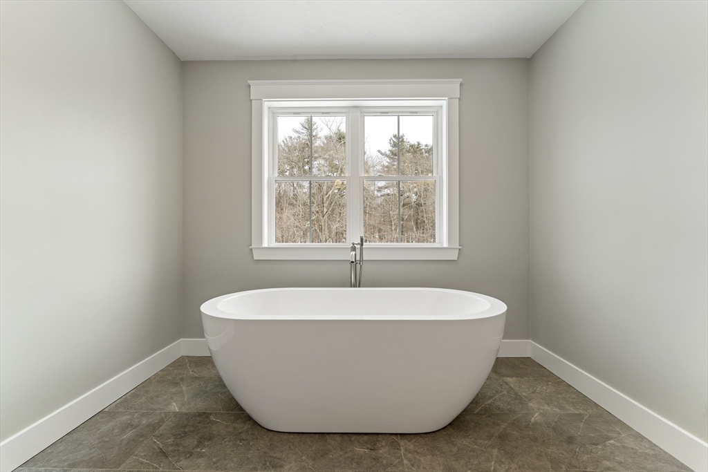 29 Thornton Street Mendon, MA 01756 - Photo 27 of 42 a white tub sitting in a bathroom