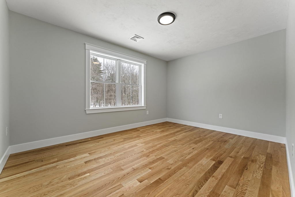 29 Thornton Street Mendon, MA 01756 - Photo 30 of 42 an empty room with wooden floor and windows