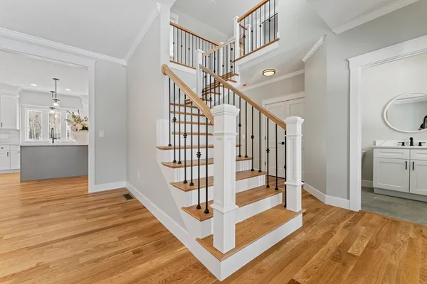 a view of entryway and hall with wooden floor