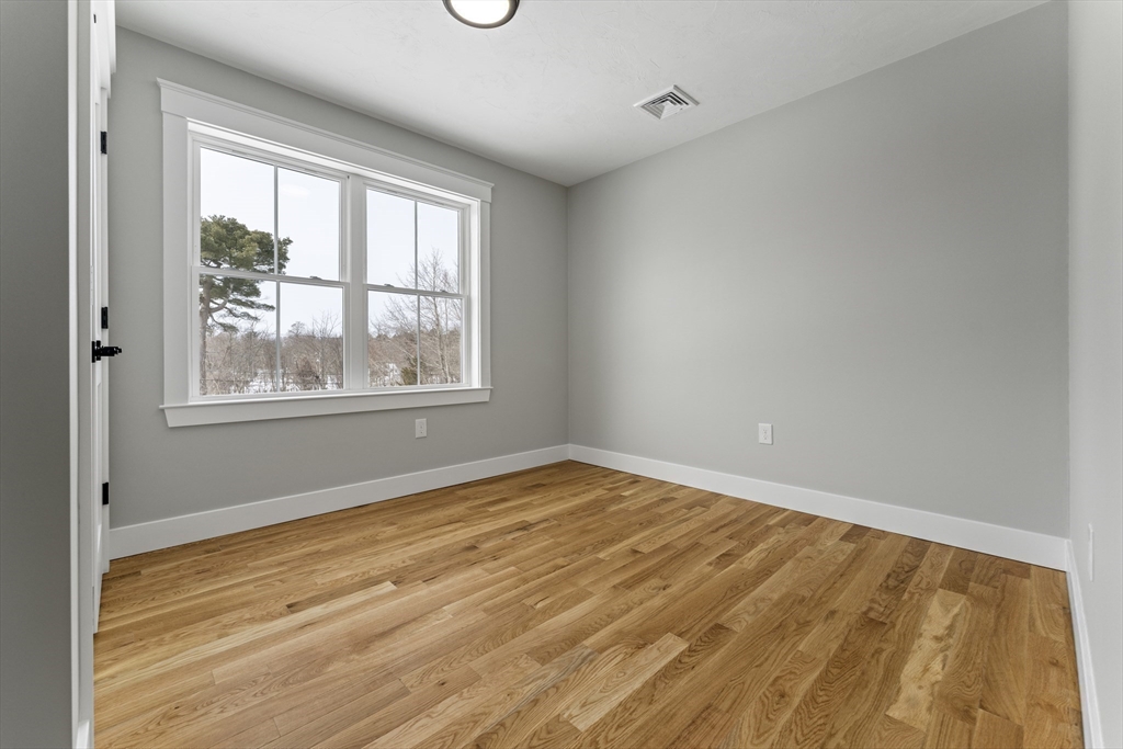 29 Thornton Street Mendon, MA 01756 - Photo 34 of 42 a view of an empty room with wooden floor and a window