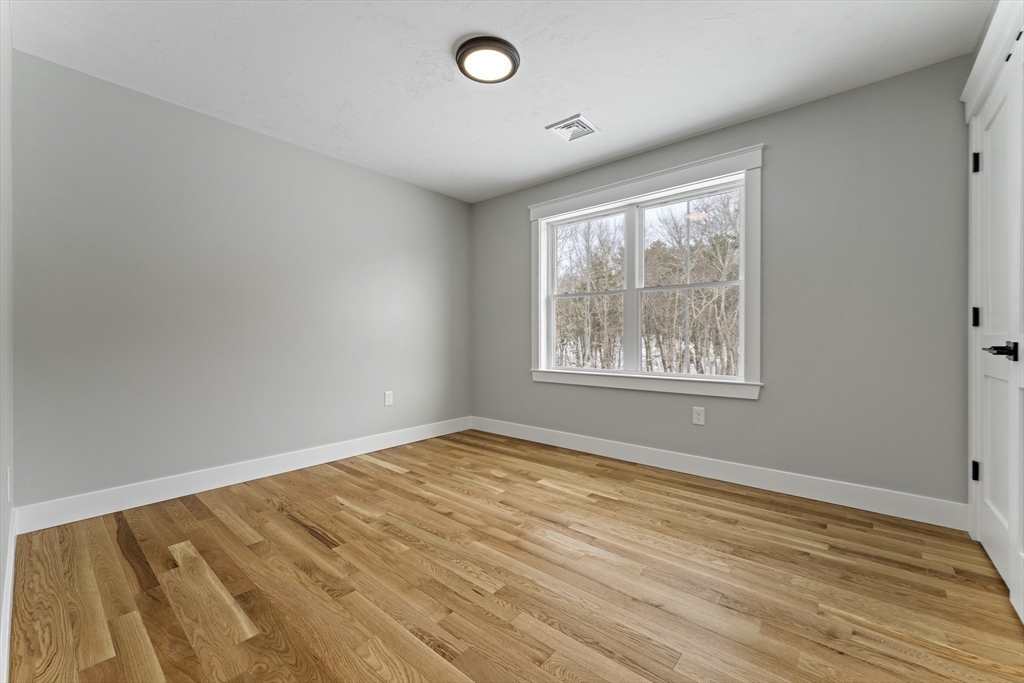 29 Thornton Street Mendon, MA 01756 - Photo 35 of 42 an empty room with wooden floor and windows