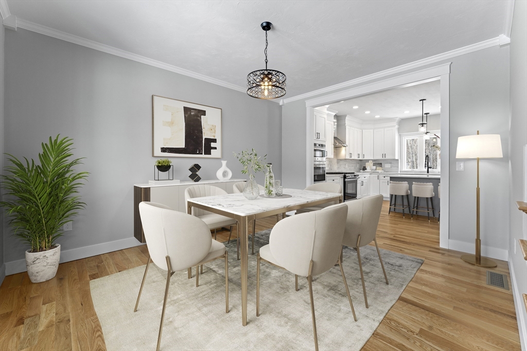 29 Thornton Street Mendon, MA 01756 - Photo 6 of 42 a dining room with wooden floor a chandelier a wooden table and chairs