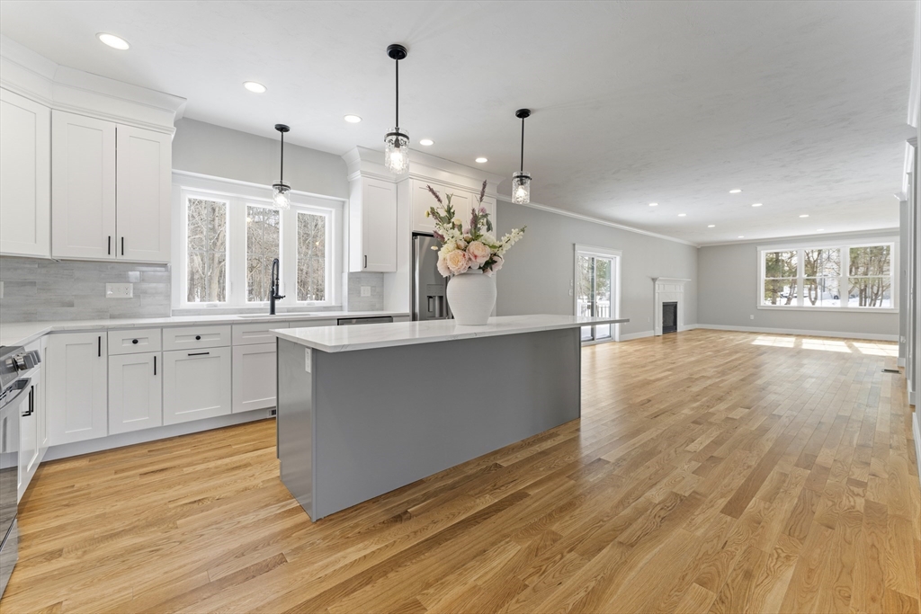 29 Thornton Street Mendon, MA 01756 - Photo 8 of 42 a large kitchen with granite countertop a large counter top a sink stainless steel appliances and cabinets