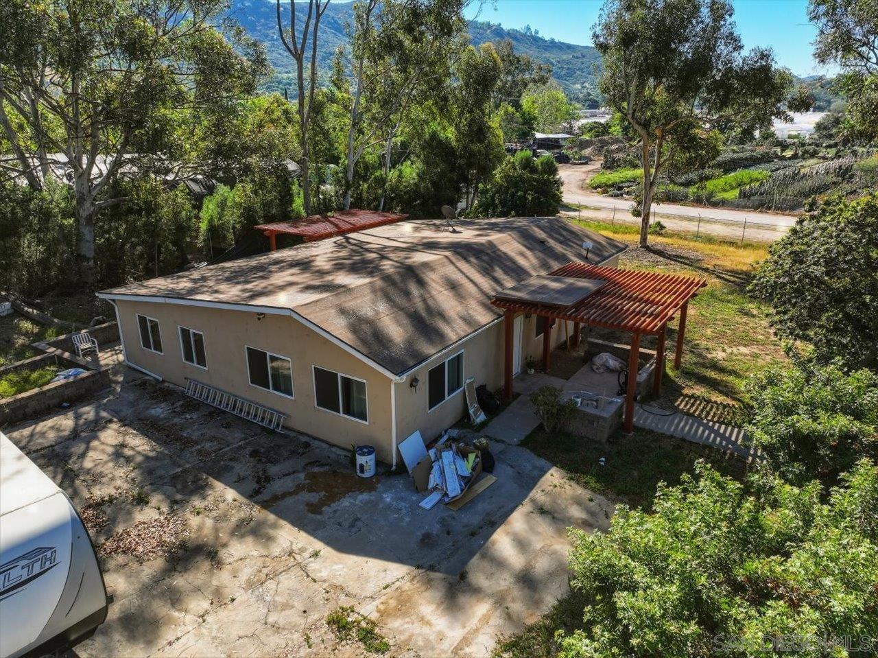 5461 Rainbow Creek Road, Unit THREE LEGA Fallbrook, CA 92028 - Photo 2 of 2 a view of a house with backyard and sitting area