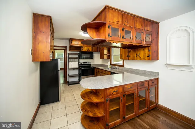 a kitchen with stainless steel appliances granite countertop a sink and a refrigerator