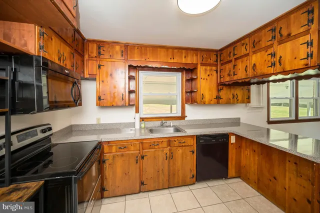 a kitchen with a sink cabinets and window