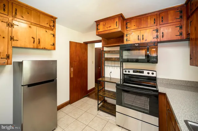 a kitchen with stainless steel appliances a refrigerator and a stove top oven