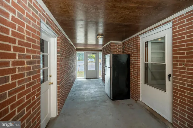 a view of a door and brick walls