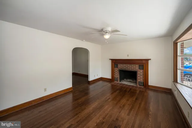 wooden floor in an empty room with a fireplace