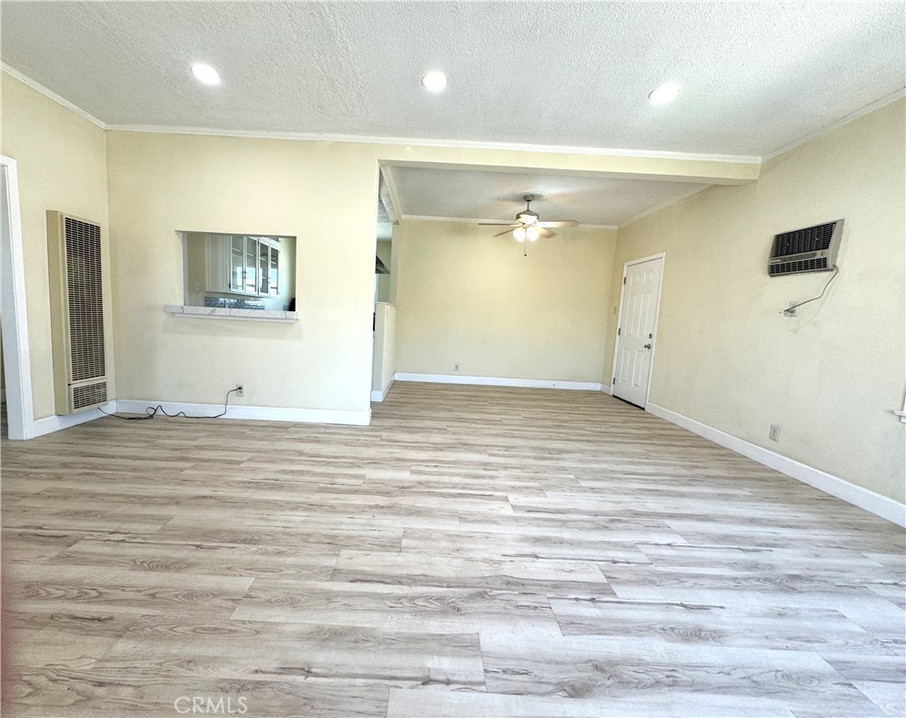 13407 Holly Street Trona, CA 93562 - Photo 24 of 25 Living Room (Wide Angle)
xpansive living room with updated recessed lighting and fresh flooring throughout. Large windows bring in natural light and highlight the home's open floorplan. Neutral tones and spacious design make this the heart of the home, ideal for entertaining or relaxing.