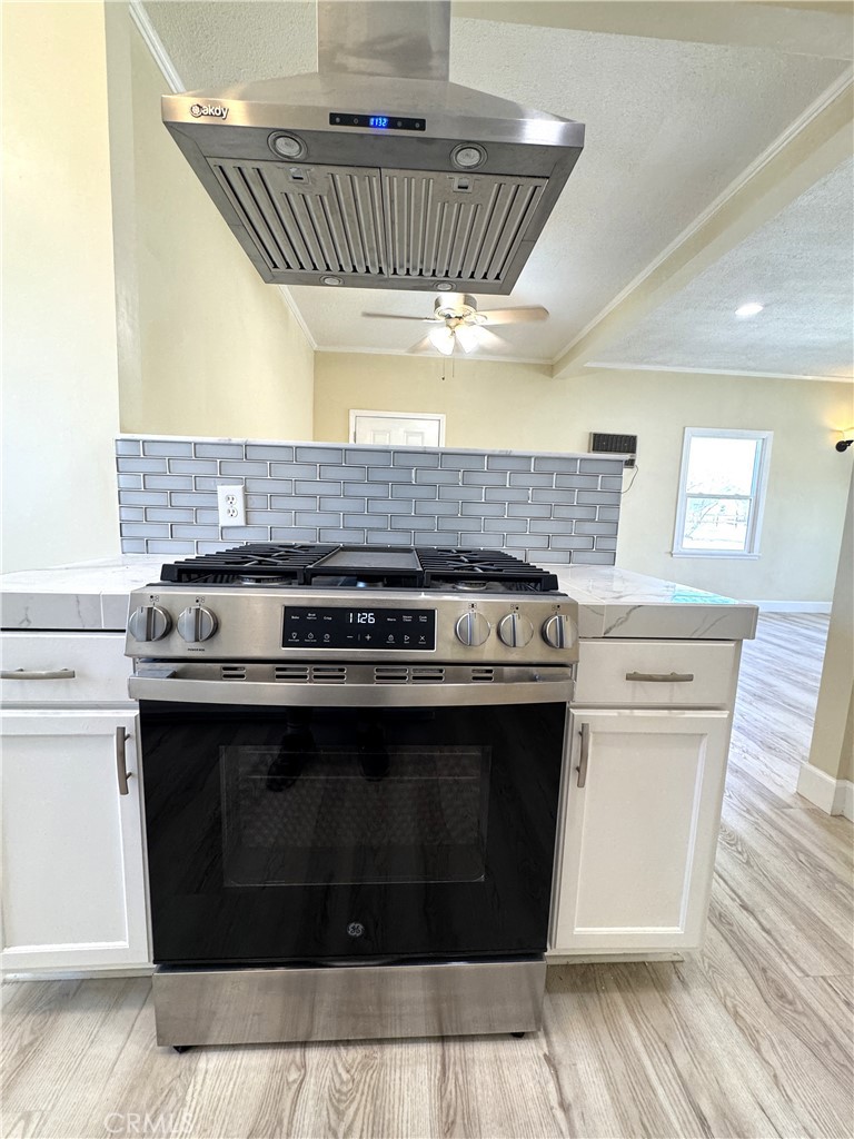 13407 Holly Street Trona, CA 93562 - Photo 12 of 25 Kitchen Feature – 13407 Holly
Modern stainless steel gas range with overhead hood vent, creating a sleek focal point for the kitchen.
Surrounded by fresh white cabinetry, marble-look counters, and subway tile backsplash.
Designed for both style and functionality, perfect for everyday cooking or entertaining.
A clean, contemporary upgrade that enhances the home’s move-in ready appeal.