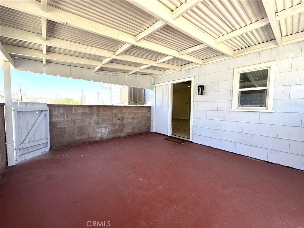 13407 Holly Street Trona, CA 93562 - Photo 16 of 25 Patio area
Generous covered patio space perfect for outdoor dining, entertaining, or enjoying desert evenings in the shade. Durable concrete flooring makes maintenance a breeze. Direct access from the home to the backyard for seamless indoor-outdoor living. Enclosed with block wall for privacy and wind protection, while still open to views and fresh air.