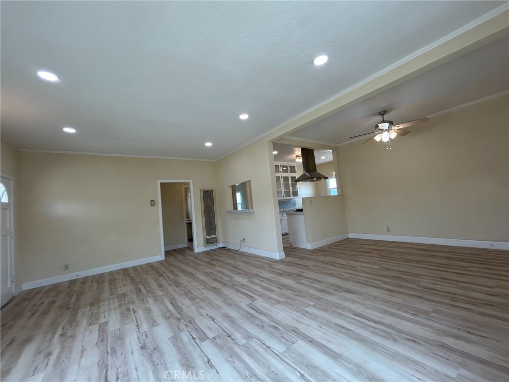13407 Holly Street Trona, CA 93562 - Photo 2 of 25 Living Room
Bright and spacious open living area with large windows that bring in tons of natural light.
Fresh, neutral paint tones paired with new wood-look flooring for a clean, modern feel.
Recessed lighting and updated fixtures create a warm and inviting atmosphere.
Open sightlines to the kitchen, perfect for entertaining.
