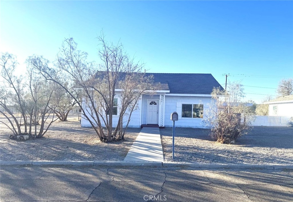 13407 Holly Street Trona, CA 93562 - Photo 23 of 25 Exterior – Of house from Street
Charming single-story home set on a spacious desert lot with mature desert trees for natural character and shade.
Freshly painted exterior gives the home a clean, updated look.
Wide lot provides room for RV parking, outdoor projects, or future landscaping.
Detached structure in back offers added flexibility for storage or workshop use.
Peaceful neighborhood setting with open skies and mountain