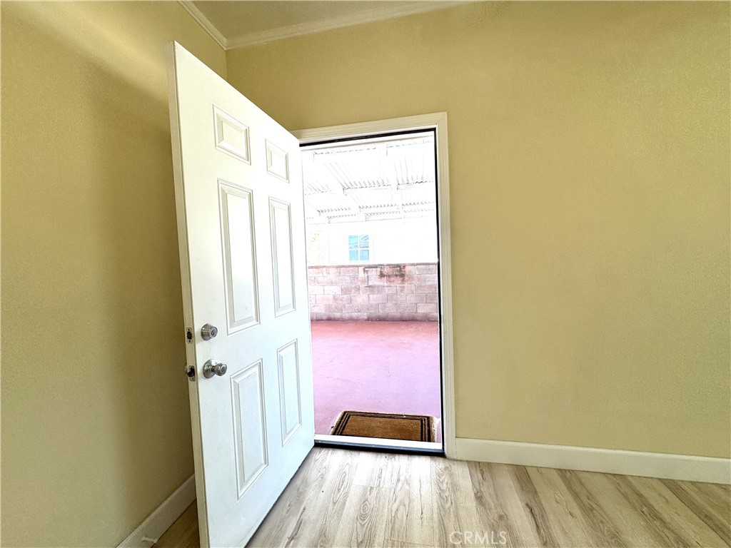 13407 Holly Street Trona, CA 93562 - Photo 10 of 25 Back Door Entry
Secondary entry door opens onto a covered patio area, perfect for outdoor seating or shade in the desert sun. Fresh flooring flows right to the doorway, maintaining the home's cohesive look. A great transition space between indoors and outdoors.