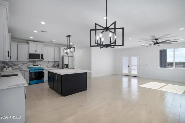 a large white kitchen with cabinets