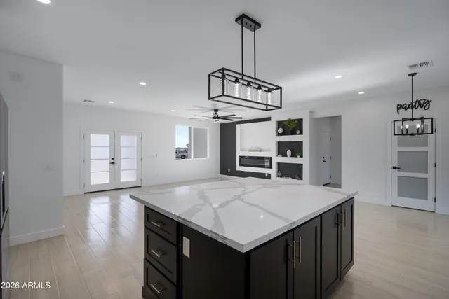 a kitchen with a center island and wooden floor