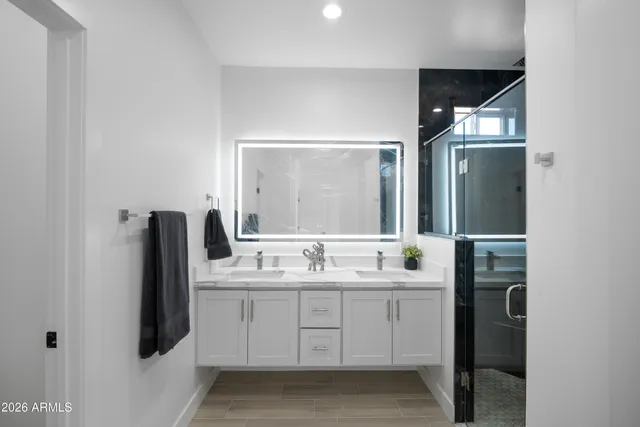 a bathroom with a double vanity sink and mirror