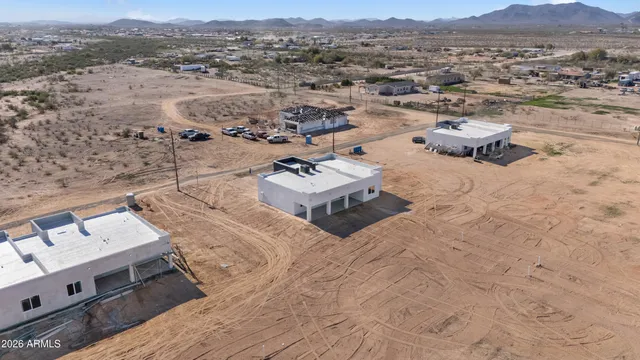 an aerial view of a house with a mountain