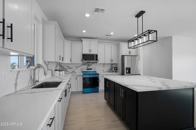 a kitchen with cabinets a sink and appliances