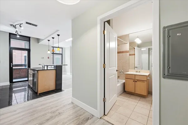 a bathroom with a granite countertop sink mirror and toilet