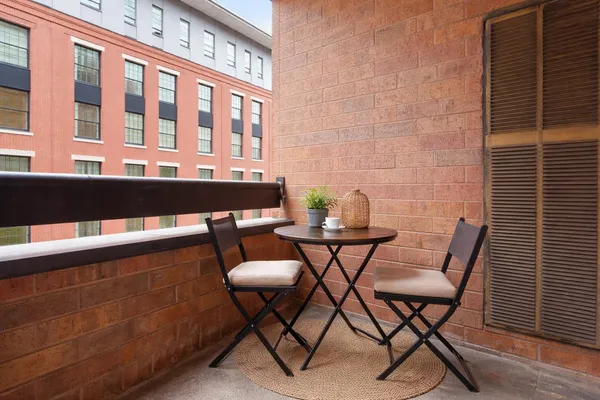 a roof deck with table and chairs