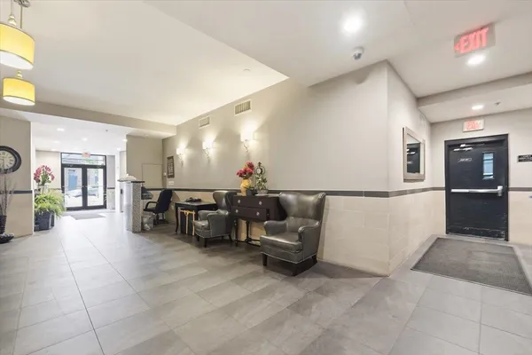 a lobby with furniture and a table