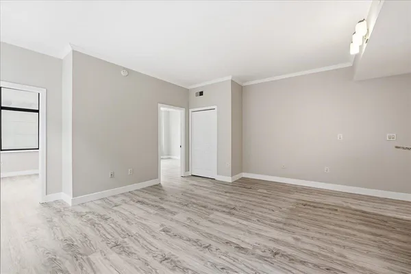 a view of an empty room with wooden floor