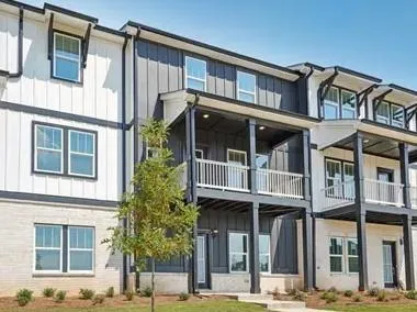 a front view of a residential apartment building with a yard