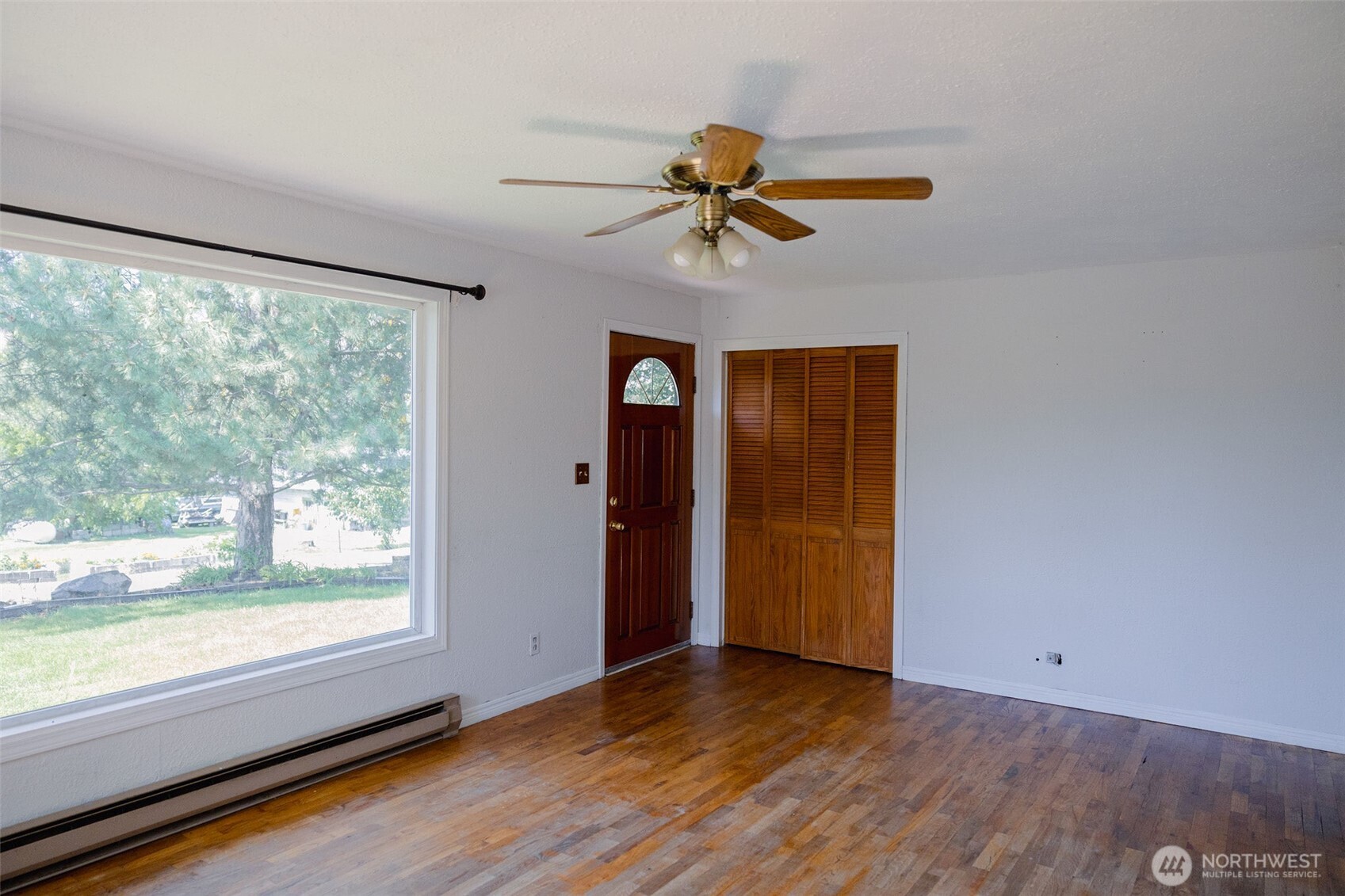 12 A Temby Road Tonasket, WA 98855 - Photo 12 of 36 wooden floor in an empty room with a window