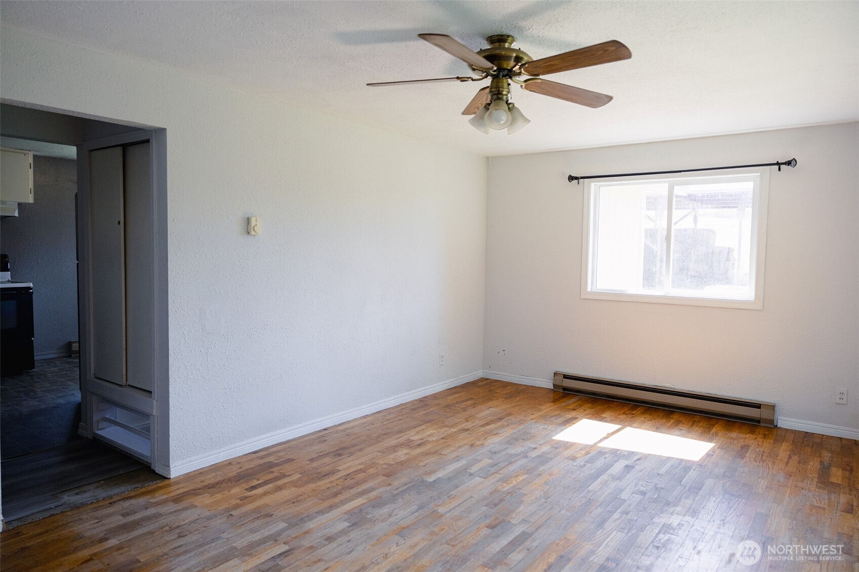 12 A Temby Road Tonasket, WA 98855 - Photo 14 of 36 a view of an empty room with wooden floor and a window