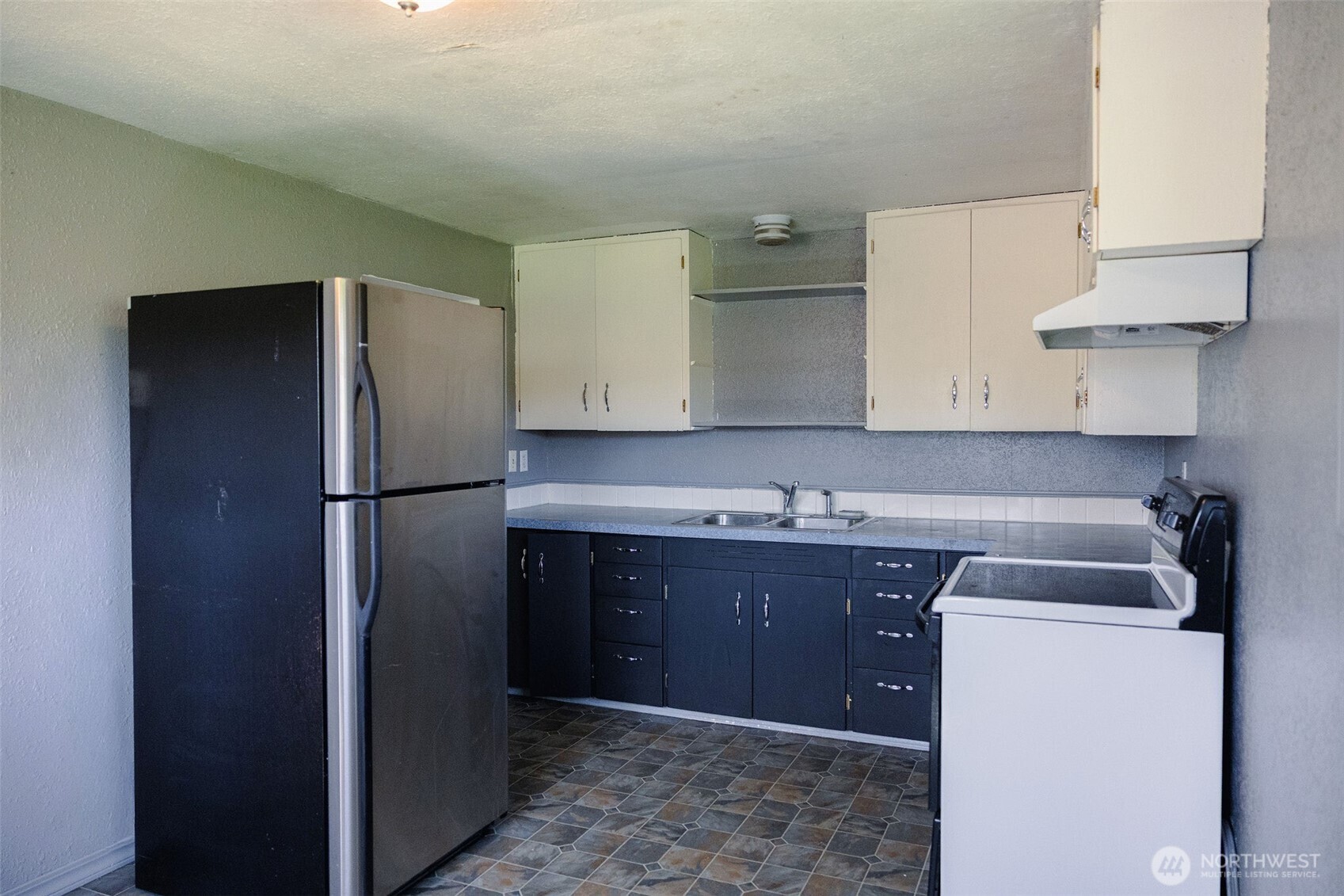 12 A Temby Road Tonasket, WA 98855 - Photo 15 of 36 a kitchen with a sink and a refrigerator
