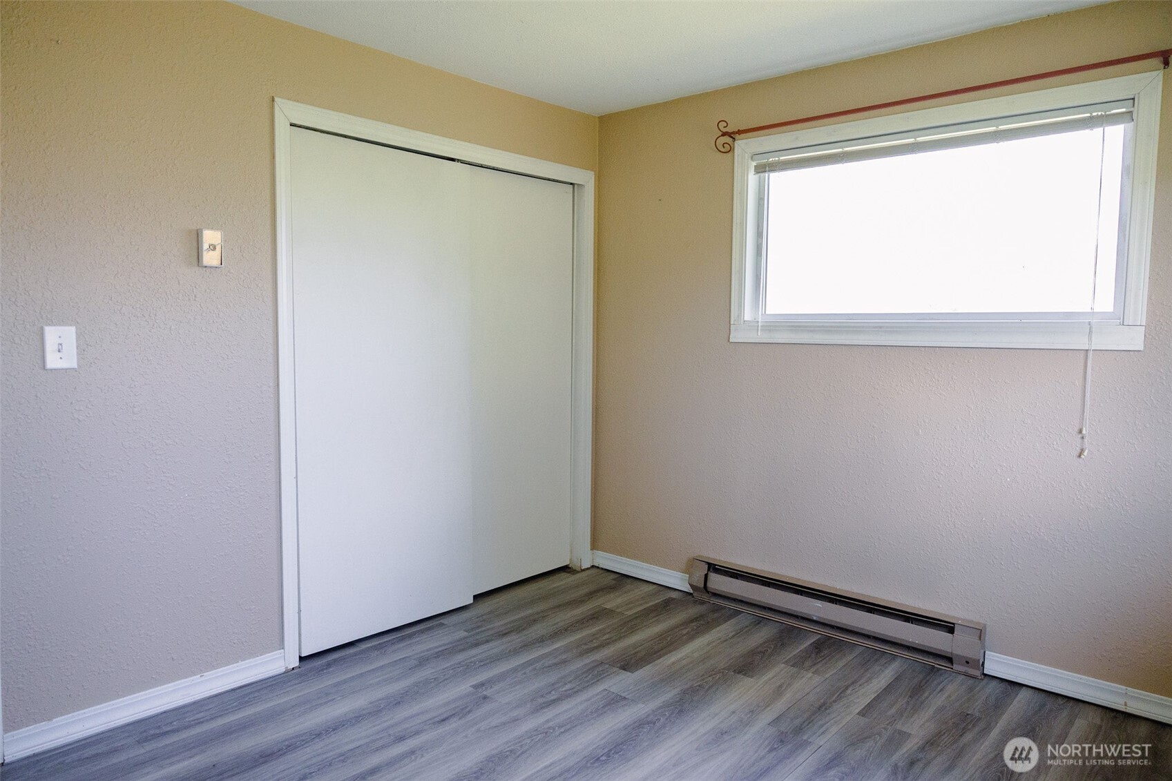 12 A Temby Road Tonasket, WA 98855 - Photo 17 of 36 a view of an empty room with wooden floor and a window