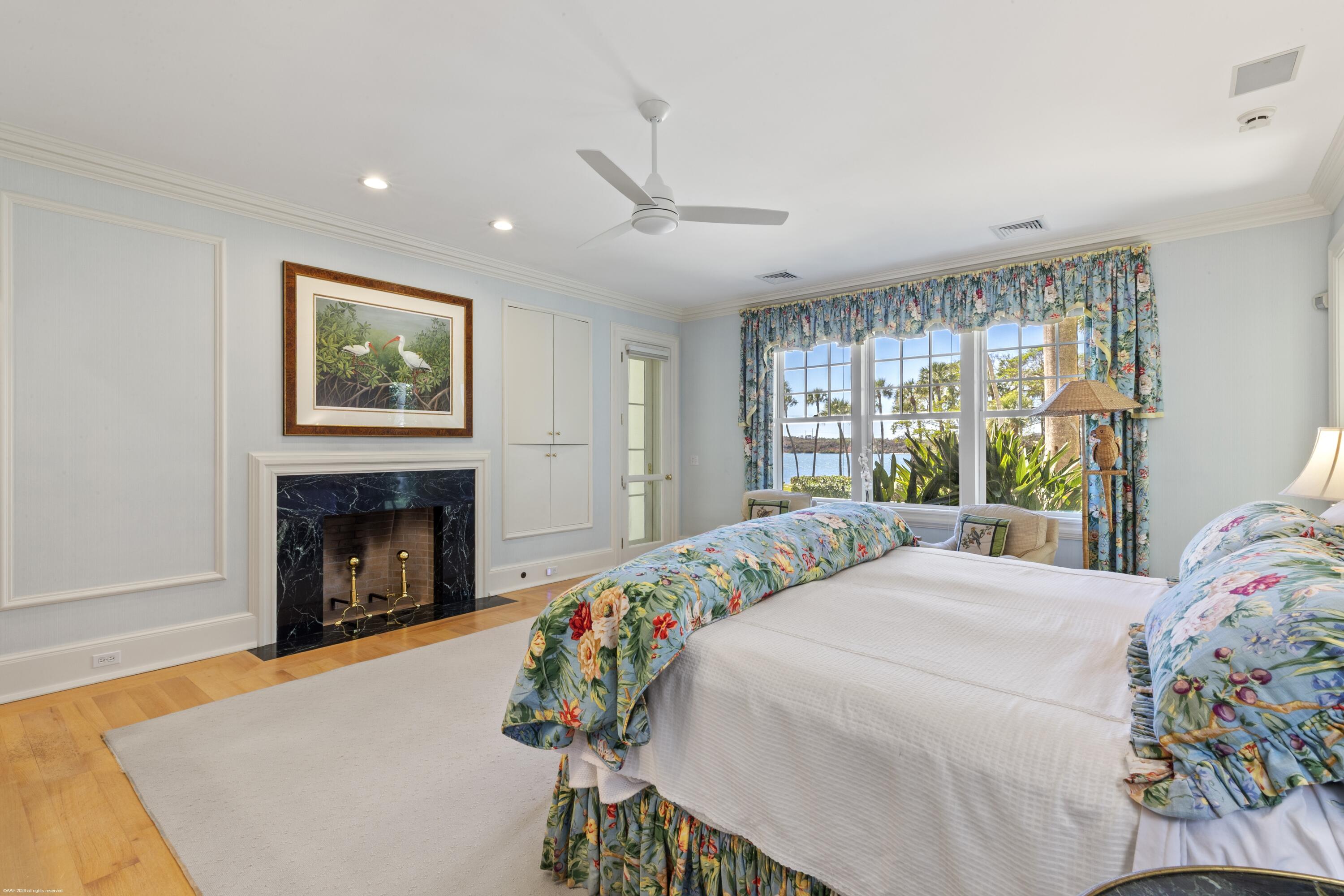 228 South Beach Road Jupiter Island, FL 33455 - Photo 19 of 40 a bedroom with a bed and a fireplace