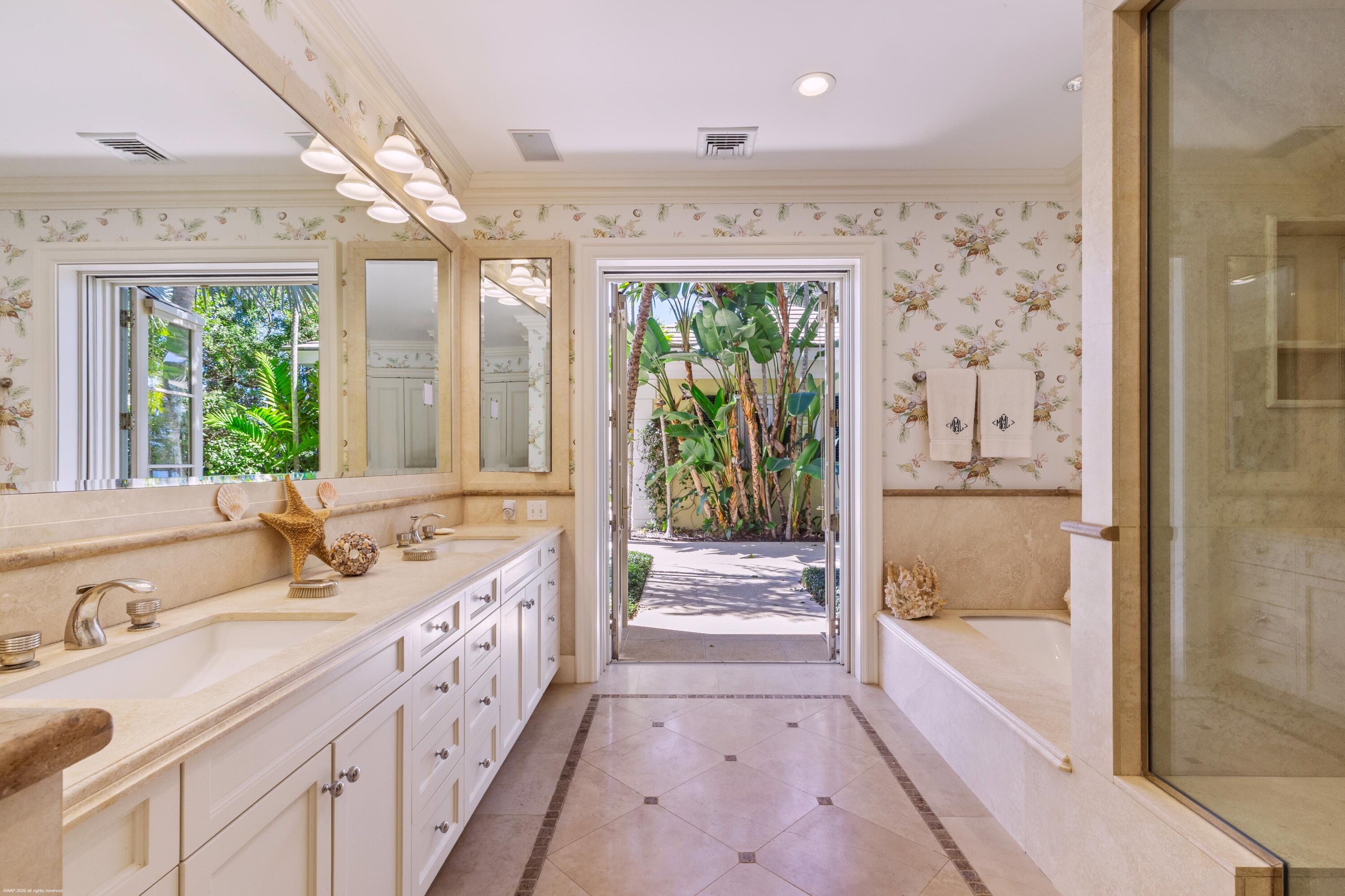 228 South Beach Road Jupiter Island, FL 33455 - Photo 20 of 40 a spacious bathroom with a tub sink and mirror