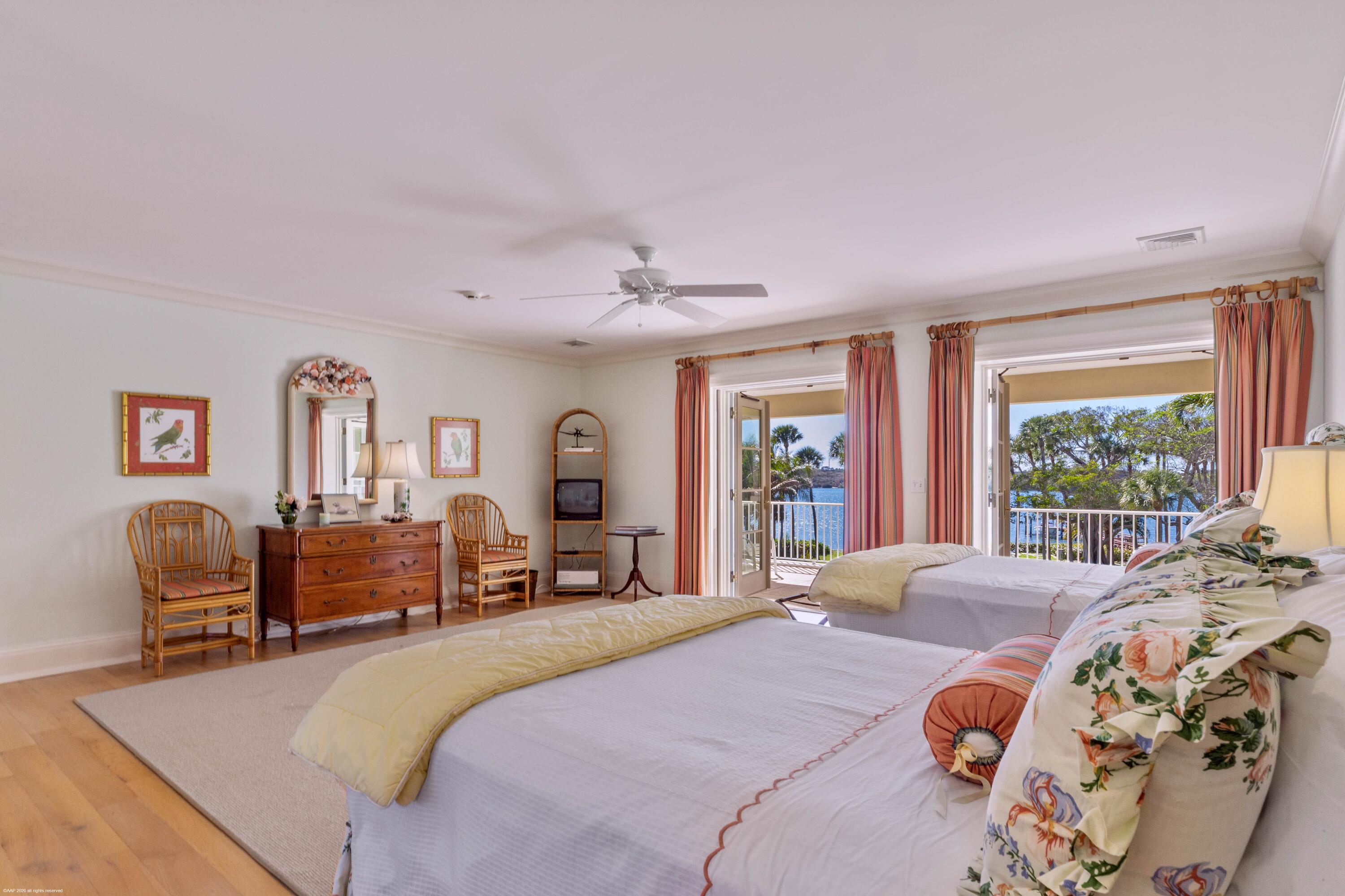 228 South Beach Road Jupiter Island, FL 33455 - Photo 23 of 40 a bedroom with a bed and wooden floor