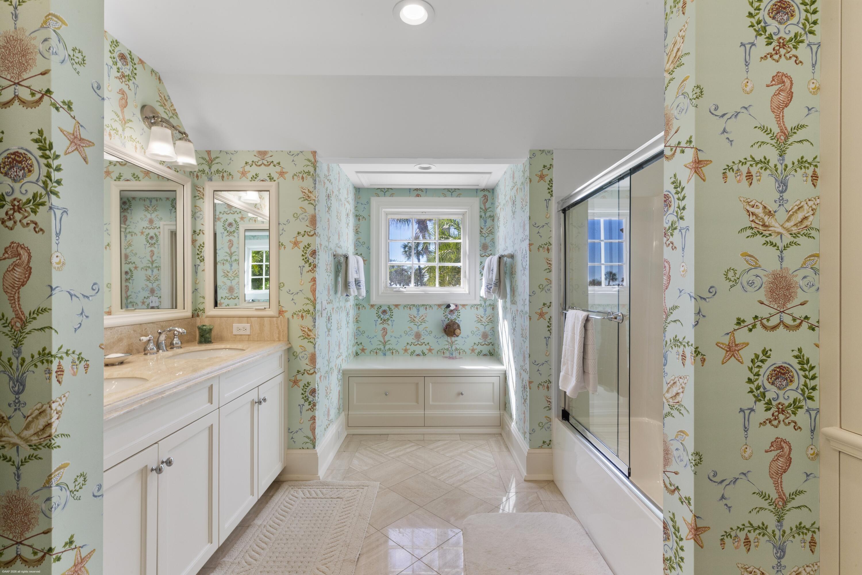 228 South Beach Road Jupiter Island, FL 33455 - Photo 24 of 40 a bathroom with a double vanity sink toilet and shower