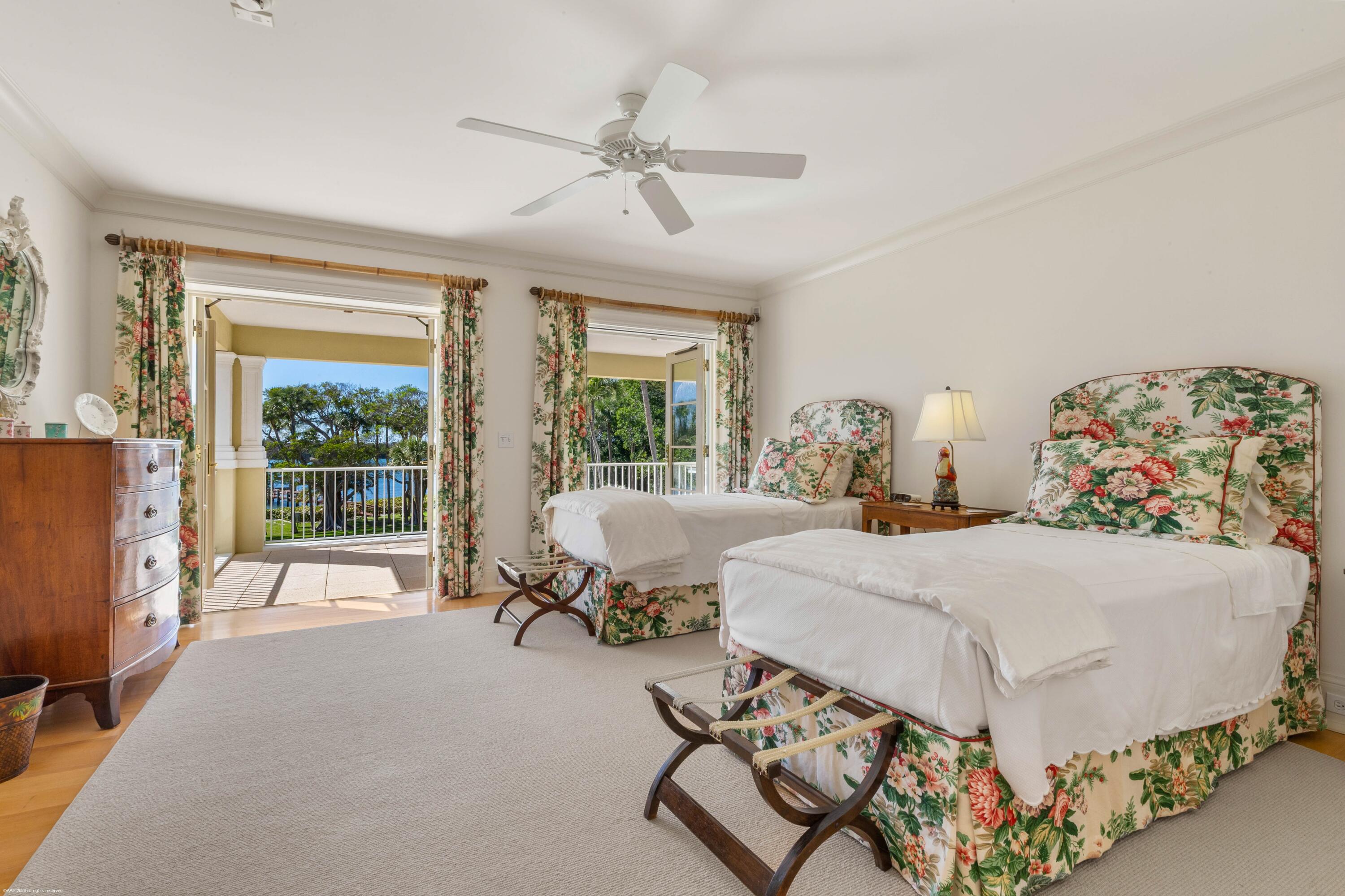 228 South Beach Road Jupiter Island, FL 33455 - Photo 25 of 40 a spacious bedroom with a bed and large windows