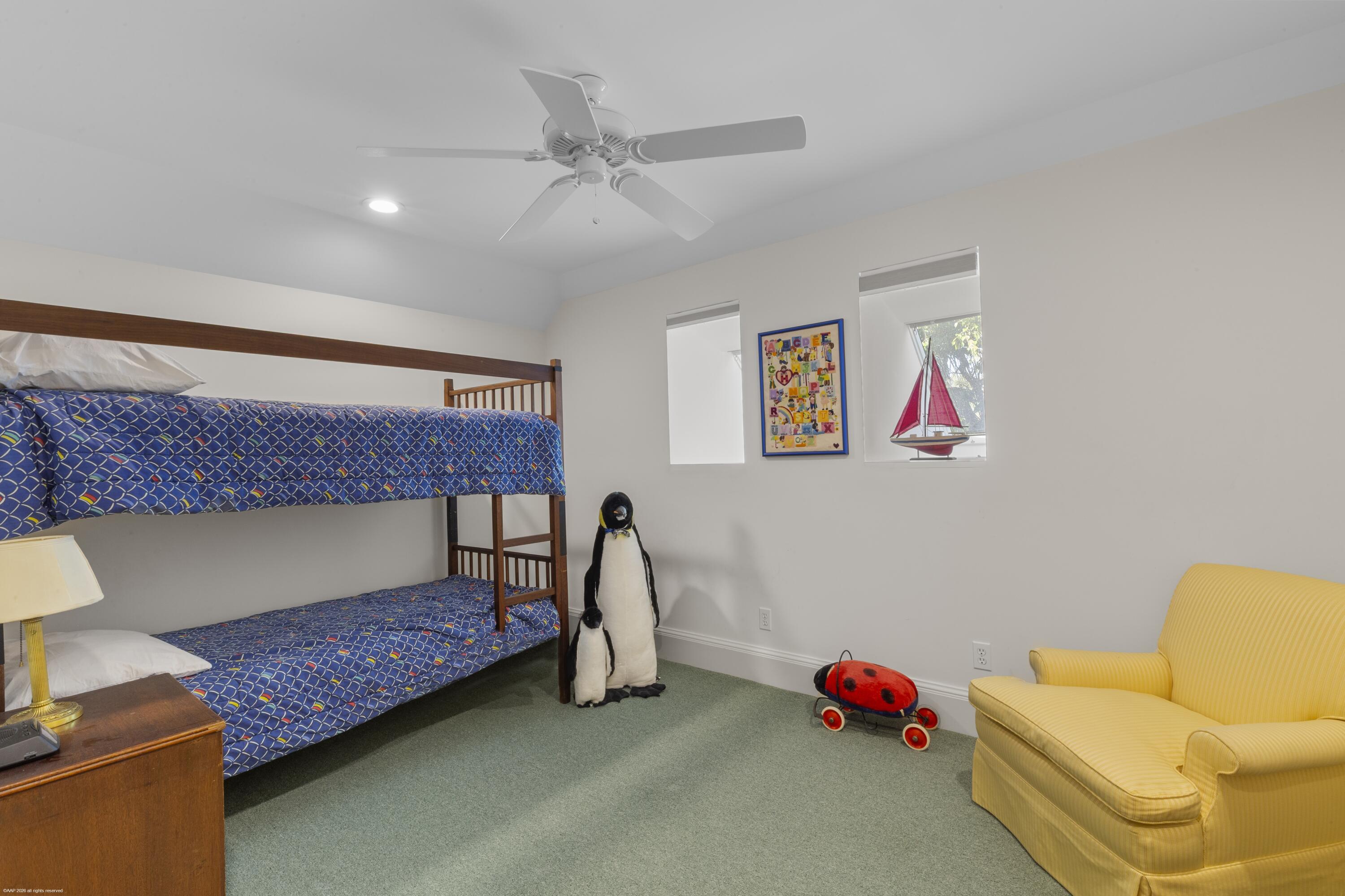 228 South Beach Road Jupiter Island, FL 33455 - Photo 26 of 40 a bedroom with a bed and a couch