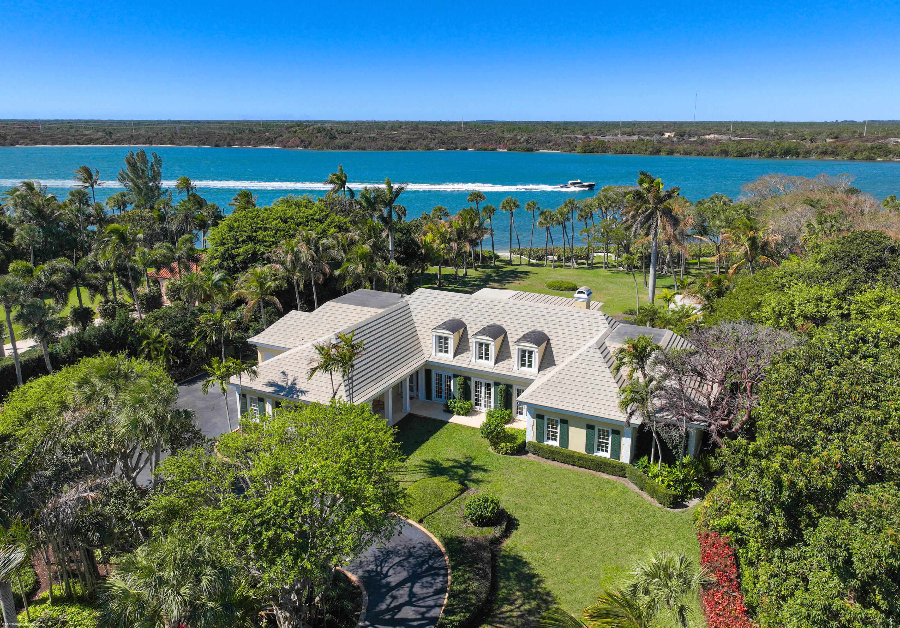 228 South Beach Road Jupiter Island, FL 33455 - Photo 3 of 40 an aerial view of a house with a lake view